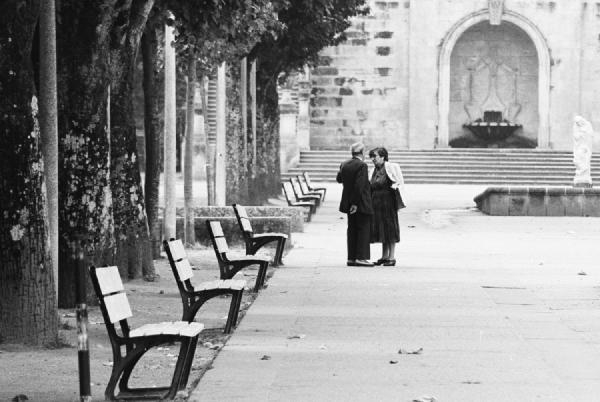 Lamego, early 1990s. This is one of my all-time favourite photographs. The rhythm of the benches leads the eye toward the two people who met there by chance. The composition feels calm and balanced, capturing a simple, human moment.