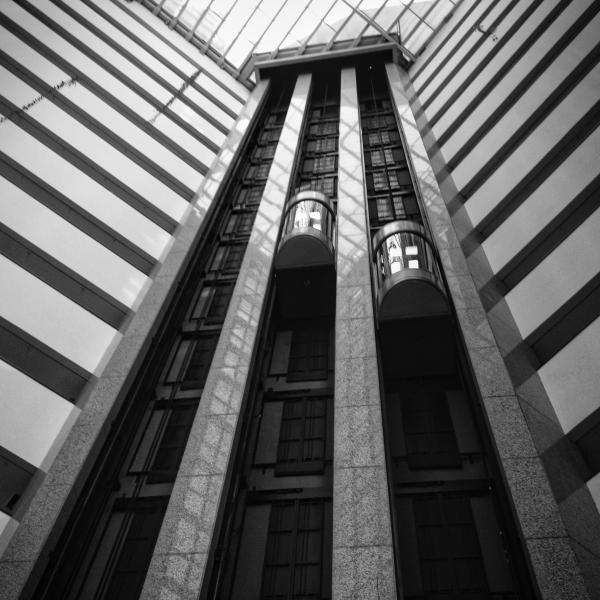 São Paulo, 2013. This is the Matsubara Hotel — my usual stay whenever visiting the city, just a short walk from Avenida Paulista. I always found the geometry of its interior striking: the symmetry of the elevators, the reflections on the marble, and the light filtering through the glass ceiling.